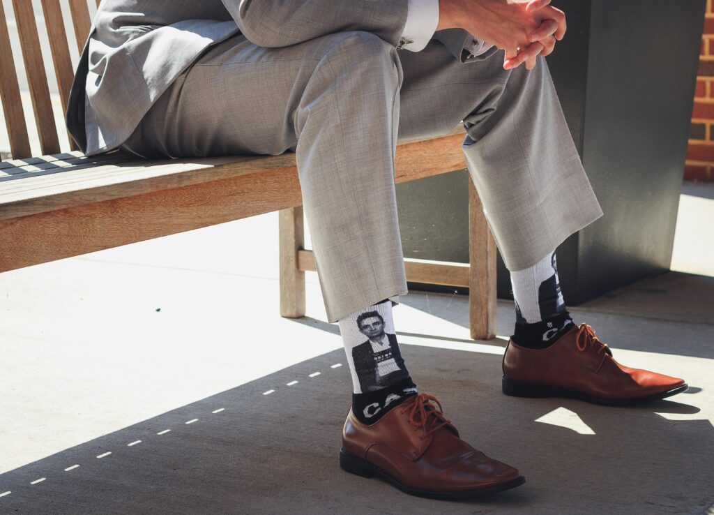 Custom corporate socks with business branding arranged in a professional setting.
